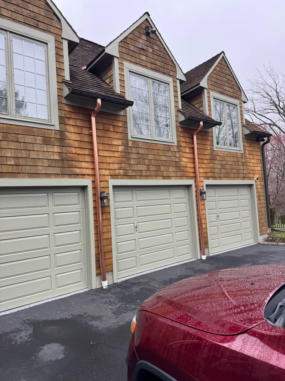 Copper downspout installation on a garage