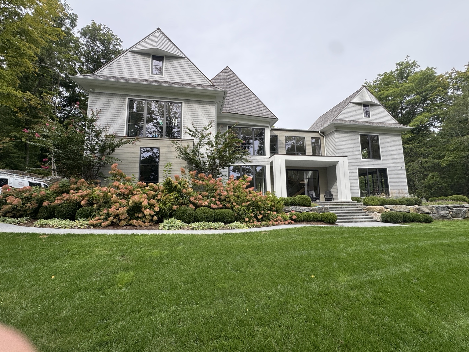 Front view of a shingle-sided home with gutters along its rooflines