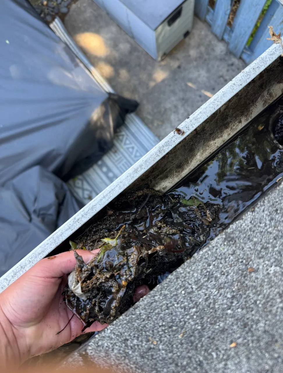 Removing packed debris from a gutter
